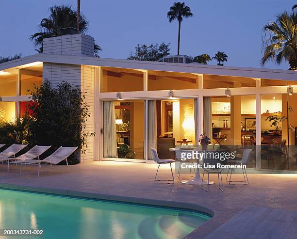 house and swimming pool lit at night - california house stock pictures, royalty-free photos & images