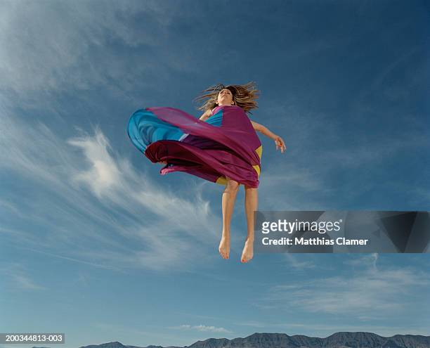 woman in mid air, low angle view (blurred motion) - float stock pictures, royalty-free photos & images