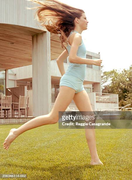 teenage girl (13-15) running on lawn, side view - panties girls stock pictures, royalty-free photos & images