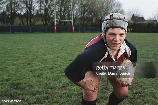 young female rugby player holding ball, close-up, portrait - rugby sport stock-fotos und bilder