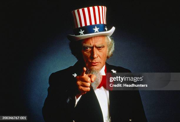 senior man dressed as 'uncle sam' pointing finger - uncle sam stock pictures, royalty-free photos & images