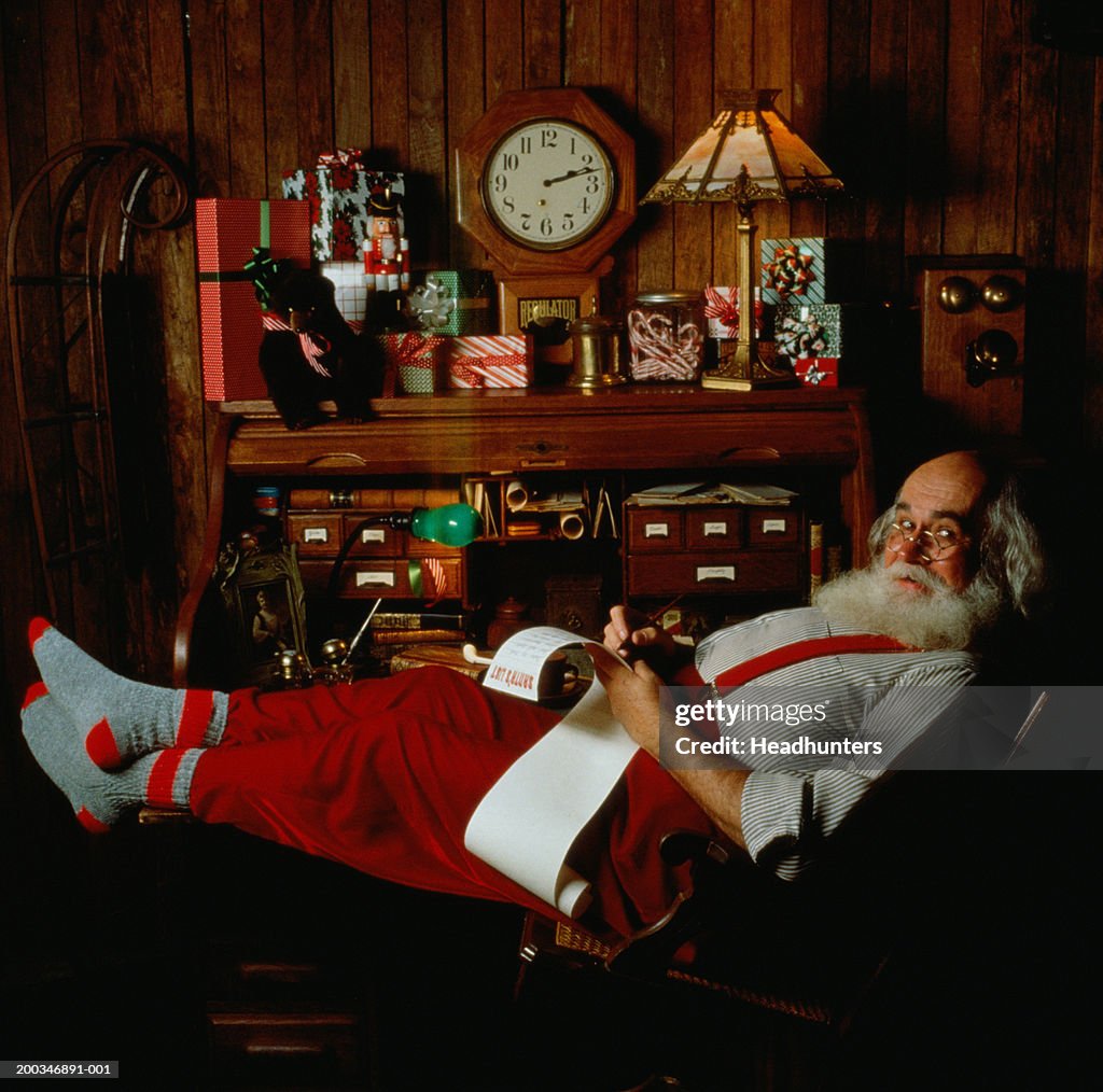 Mature man dressed as Santa Claus in study, portrait