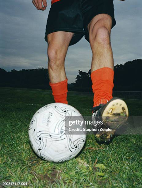 soccer player getting ready to kick ball, low angle view - chuteira imagens e fotografias de stock