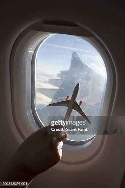 boy (11-13) riding in airplane, holding model airplane, close-up - model aeroplane stock pictures, royalty-free photos & images