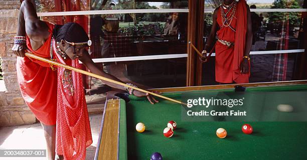 kenya, masai men playing billiards (blurred motion) - billards stock pictures, royalty-free photos & images