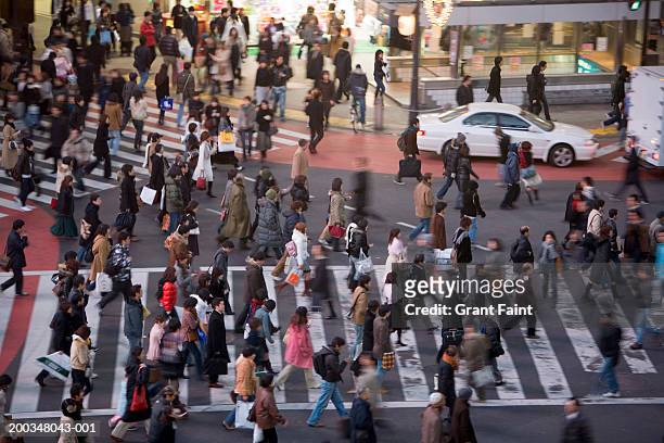 japan, tokyo, shibuya, commuters, elevated view (blurred motion) - day and night image series stock pictures, royalty-free photos & images