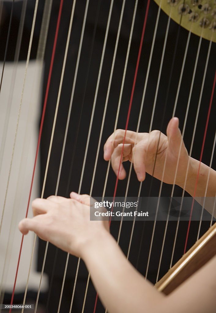 Woman playing harp, close-up