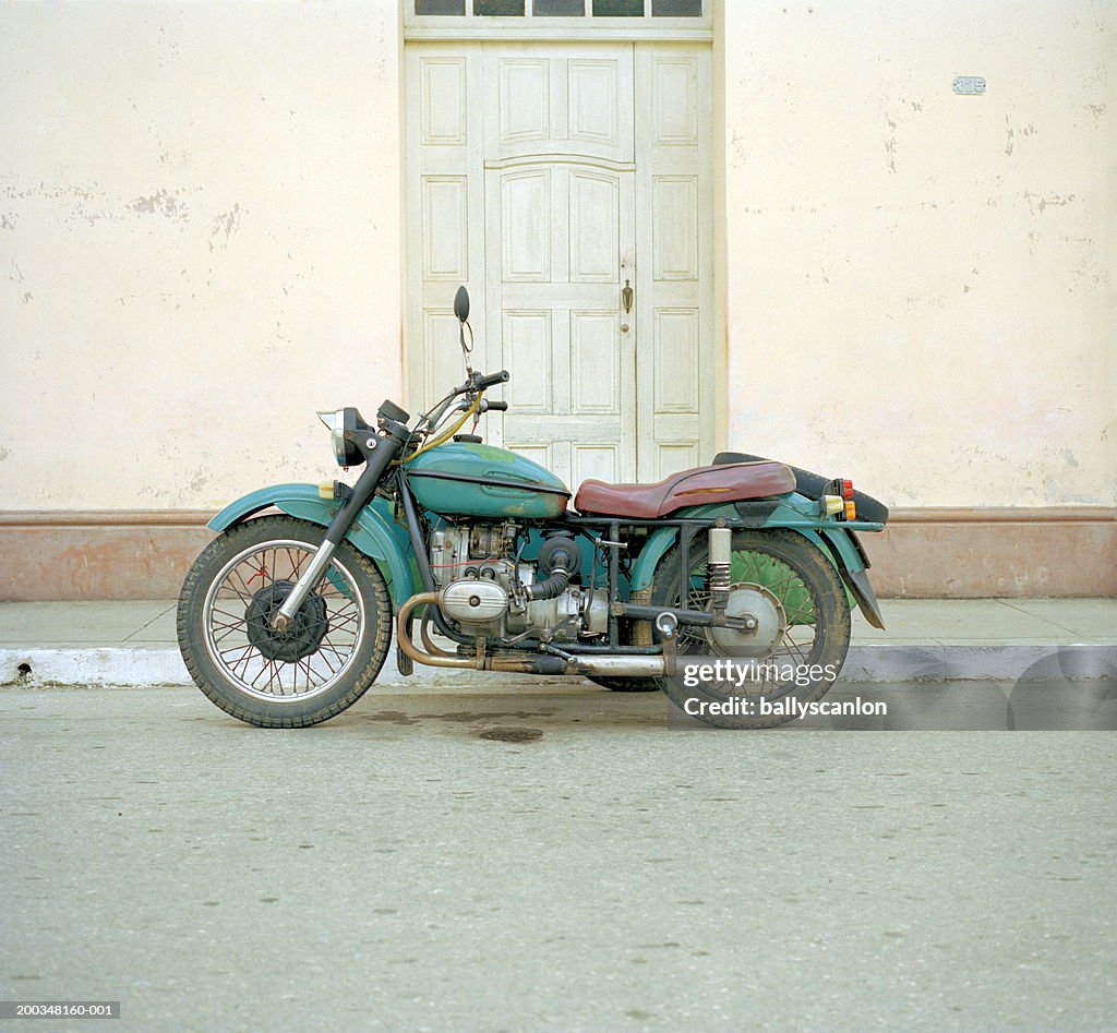 Old motorcycle on street, side view