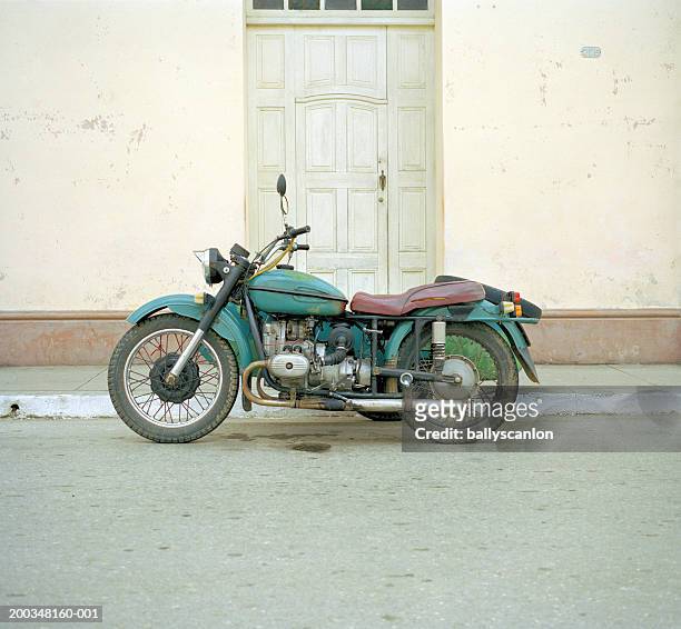 old motorcycle on street, side view - vintage motorcycle fotografías e imágenes de stock