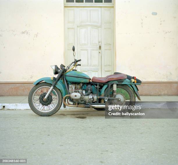 old motorcycle on street, side view - vintage motorcycle stock pictures, royalty-free photos & images