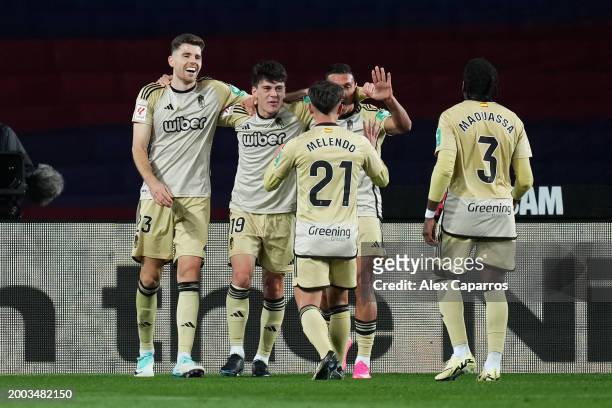 Facundo Pellistri of Granada CF celebrates with teammates after scoring his team's second goal during the LaLiga EA Sports match between FC Barcelona...