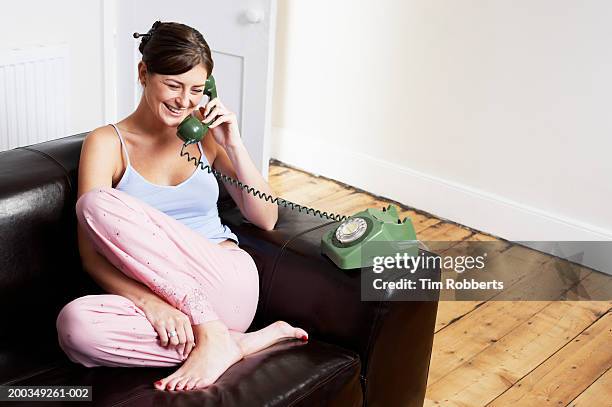 young woman on telephone laughing - leather vest stock pictures, royalty-free photos & images