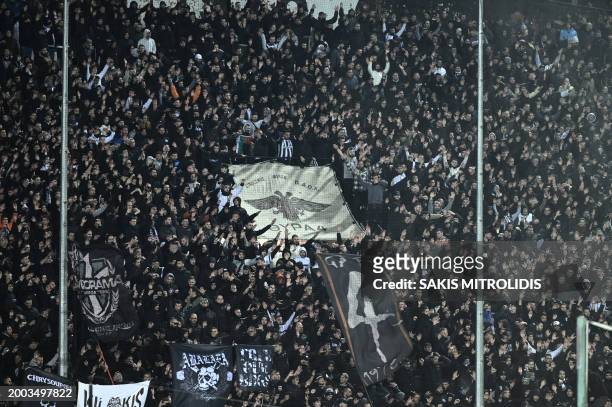 Supporters of Paok Thessaloniki football club cheer at the Toumpa stadium in Thessaloniki before a Greek Cup football match between Paok and...
