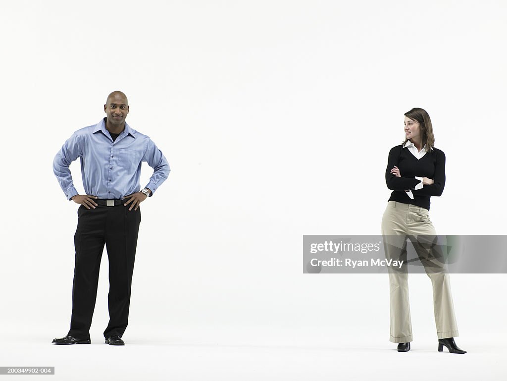 Man and woman standing apart, woman looking at man