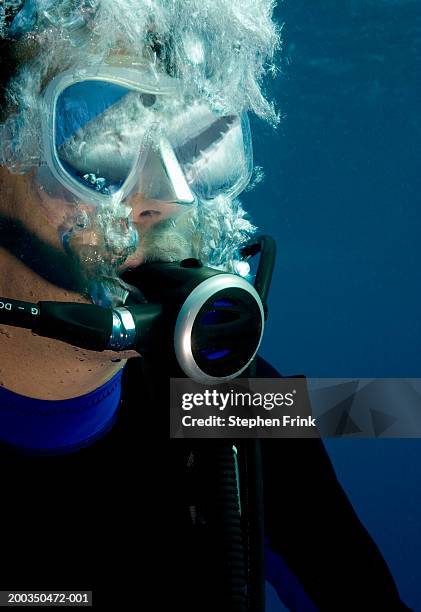 man wearing diving gear underwater, shark reflecting in mask - mask confrontation stock pictures, royalty-free photos & images