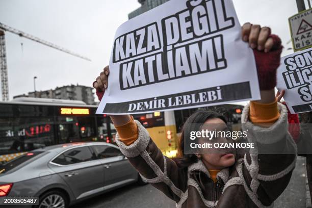 Protesters hold placards reading "It's not an accident, it's a massacre" as they gather in front of "Calik Holding", in Istanbul on February 14...