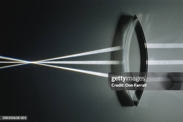 light rays refracted by convex lens, close-up - konvex stock-fotos und bilder