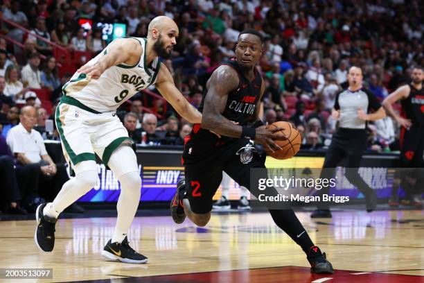 Terry Rozier of the Miami Heat drives against Derrick White of the Boston Celtics during the third quarter of the game at Kaseya Center on February...