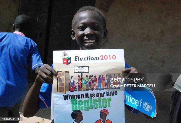 Sudanese child holds a poster to mark the launch of voter registration for the upcoming elections in the southern capital of Juba on October 31,...