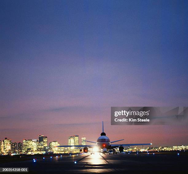 usa, massachusetts, boston, airplane on runway, night - boston logan international airport stock pictures, royalty-free photos & images