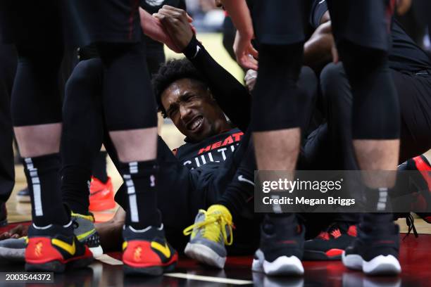 Josh Richardson of the Miami Heat lays on the ground after suffering an apparent injury during the second quarter of the game against the Boston...