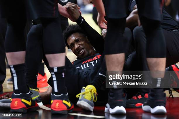 Josh Richardson of the Miami Heat lays on the ground after suffering an apparent injury during the second quarter of the game against the Boston...