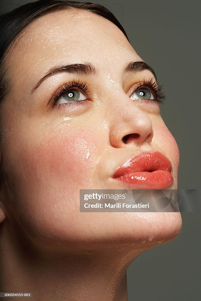 Young woman perspiring, puckering lips, close-up