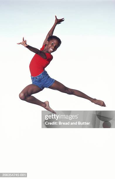 girl (9-11) dancing in mid leap - young girl white background stock pictures, royalty-free photos & images