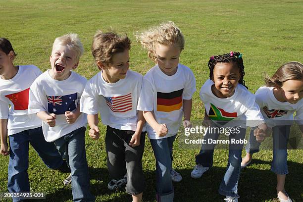 children (6-7 years) in national flag t-shirts, lined up for a race - international race stock pictures, royalty-free photos & images