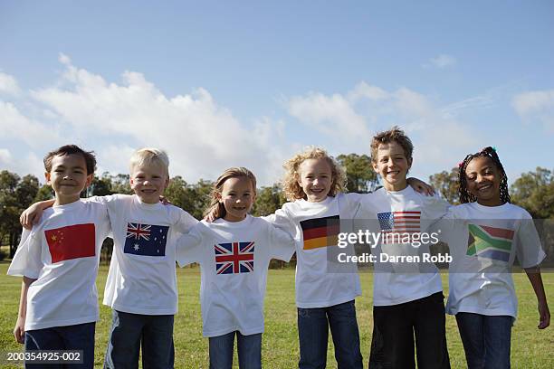 children (6-7 years) in national flag t-shirts standing arm in arm - day 7 fotografías e imágenes de stock