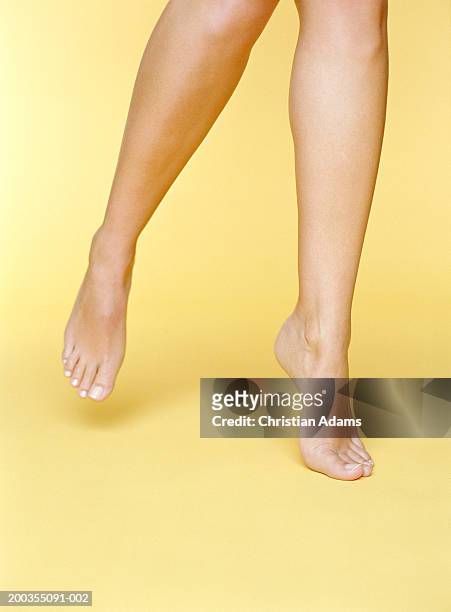 young woman balancing on toes of one foot, close-up - tiptoe stock pictures, royalty-free photos & images