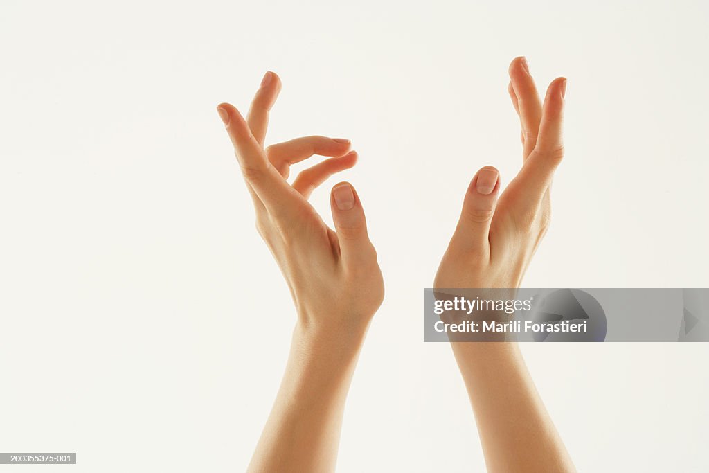 Young woman with hands in air, close-up