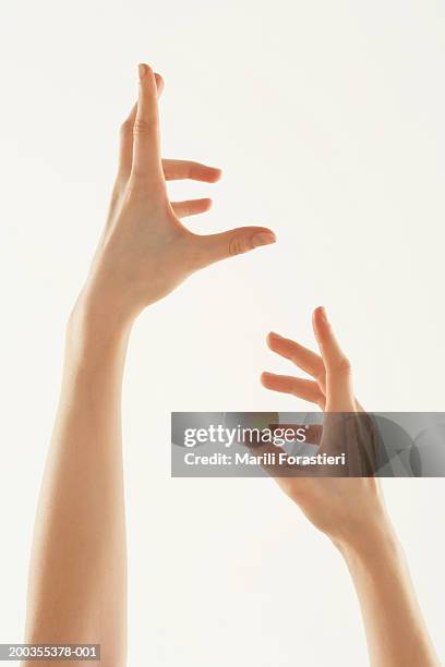 young woman with hands in air, close-up - out of reach stock pictures, royalty-free photos & images