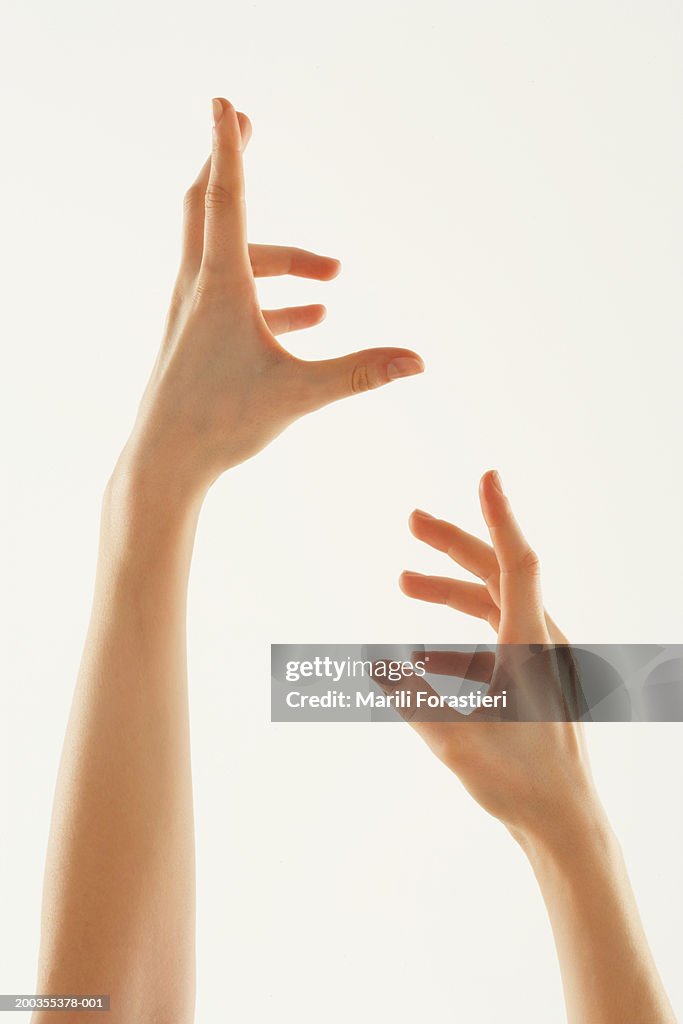 Young woman with hands in air, close-up