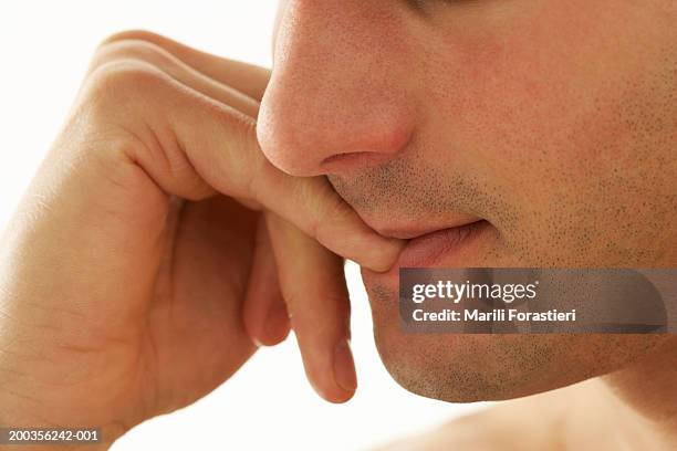 young man biting nails, close-up - nail biting stock pictures, royalty-free photos & images