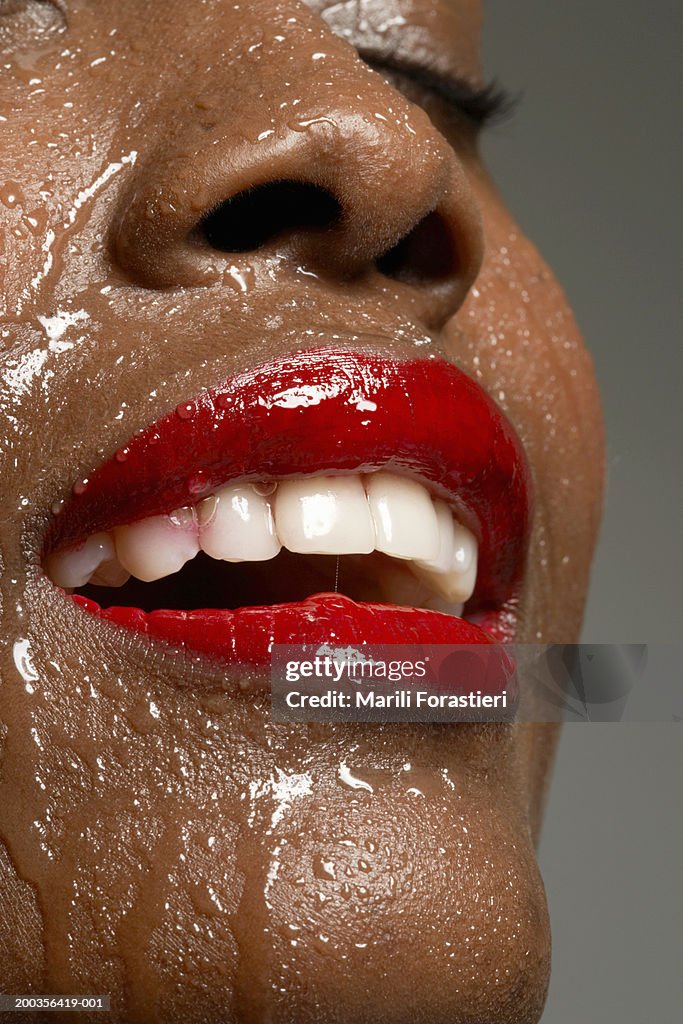 Young woman perspiring, smiling, close-up