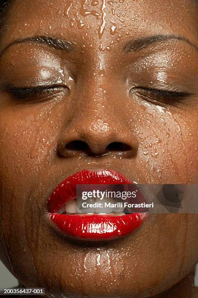 young woman with eyes closed perspiring, close-up - woman full frame stock pictures, royalty-free photos & images