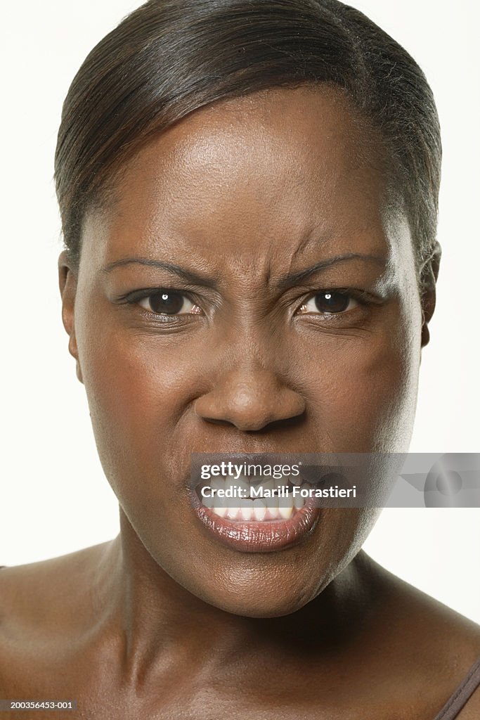 Young woman scowling, portrait, close-up