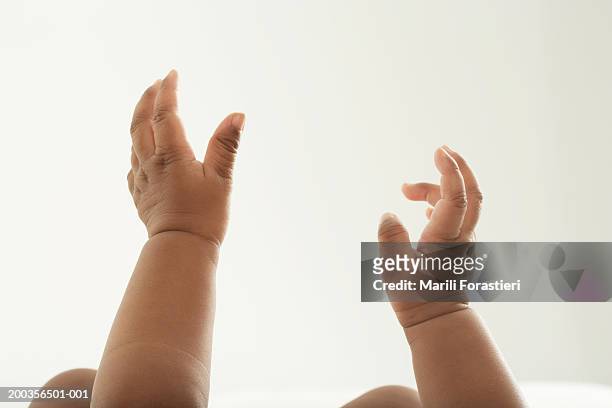 baby girl (6-9 months) reaching upward, close-up - baby hands ストックフォトと画像