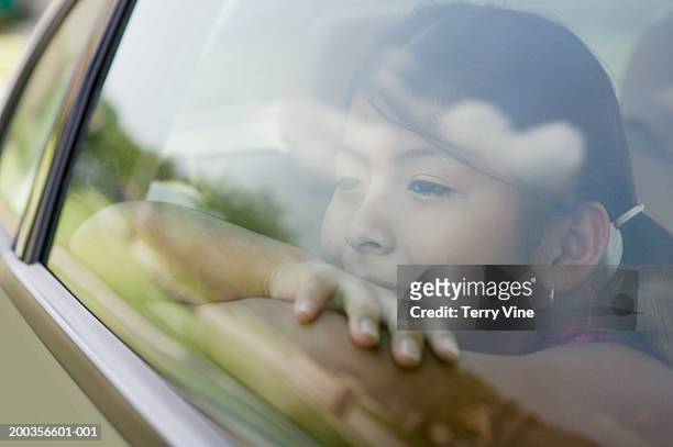 girl (7-9) looking out of car window - looking out car window stock pictures, royalty-free photos & images