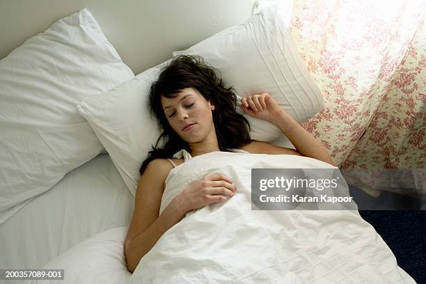 young woman asleep in bed, close-up, elevated view - man sleeping pillow stock-fotos und bilder