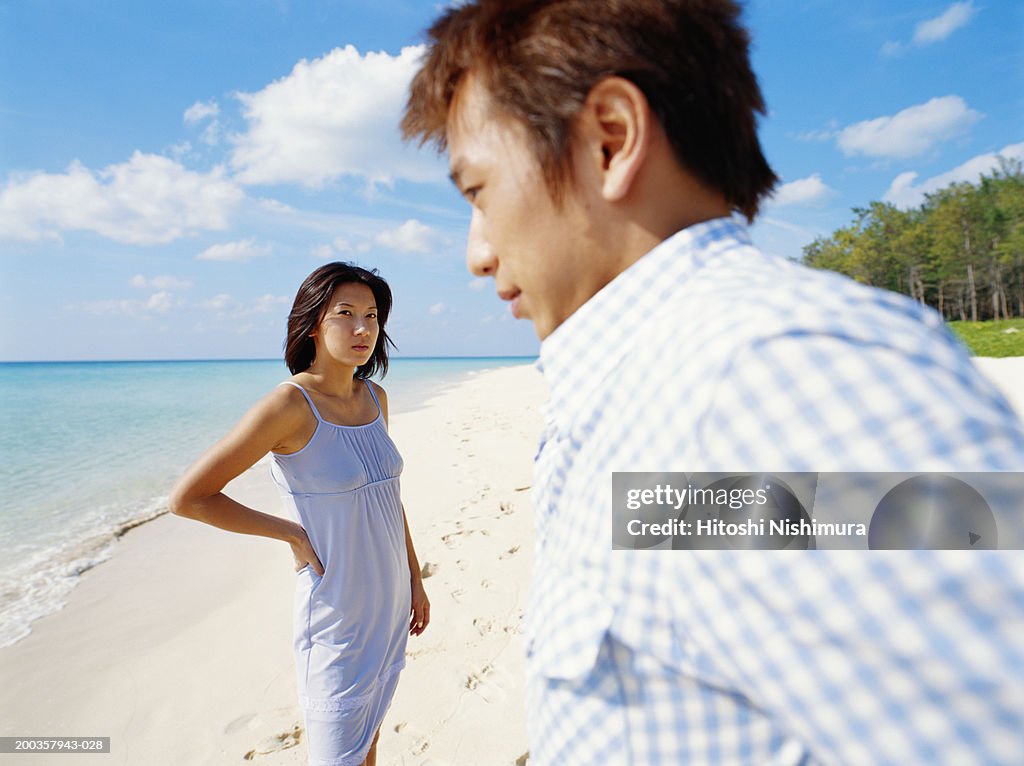 Young couple on beach (focus on woman)