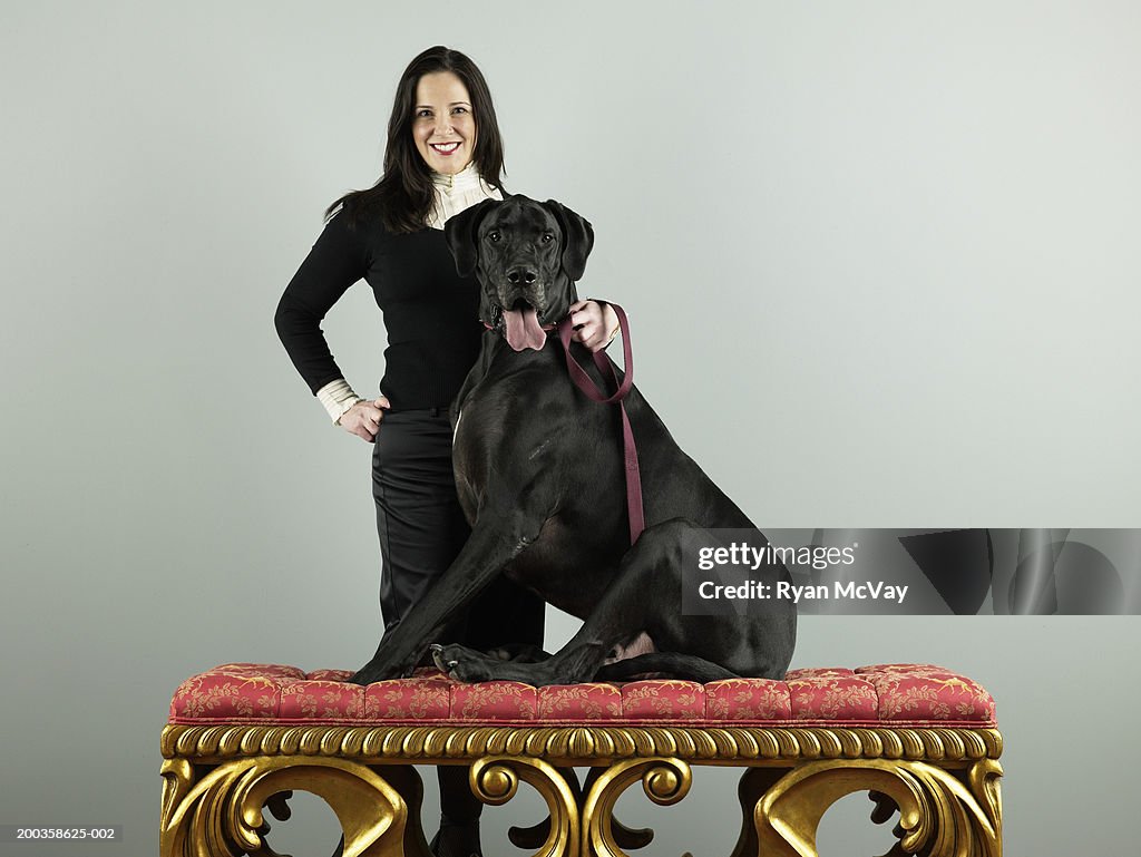 Woman with Great Dane, Great Dane sitting on bench, portrait