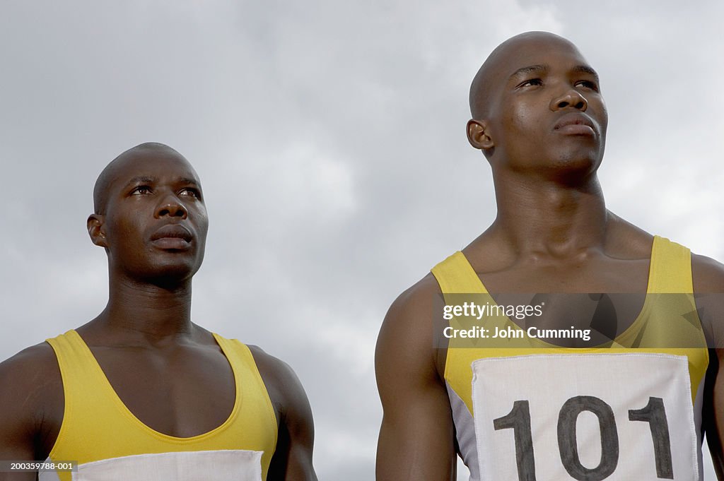 Two young male athletes, close-up, low angle view