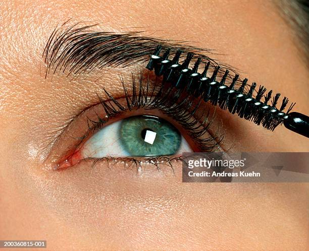 woman applying eyelash makeup, close-up - eyebrow stock pictures, royalty-free photos & images