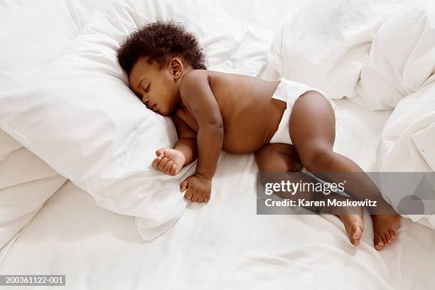 baby girl (8-11 months) sleeping on bed, elevated view - diapers stock pictures, royalty-free photos & images