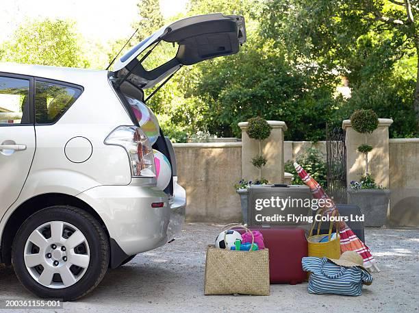 car with boot open and beach equipment and cases - summer travel bag stock pictures, royalty-free photos & images