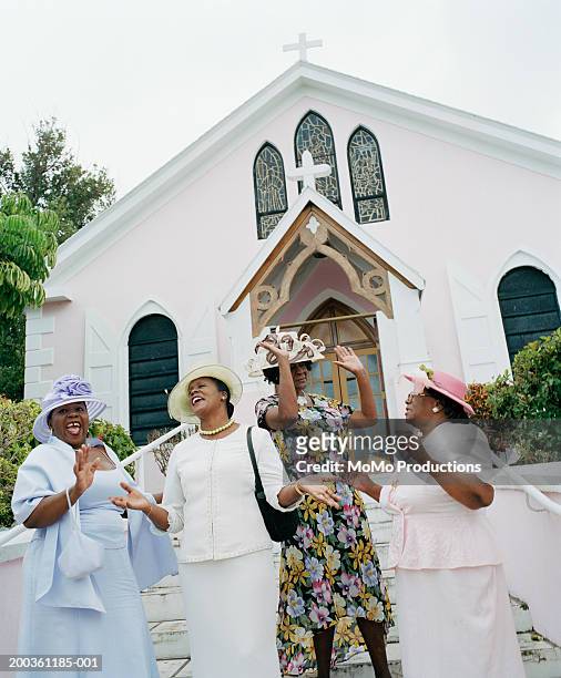 mature and senior women laughing outside church - sunday best stock pictures, royalty-free photos & images