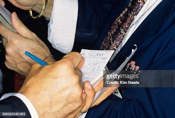new york stock exchange transactions, close-up of traders hands - new york stock exchange people stock pictures, royalty-free photos & images