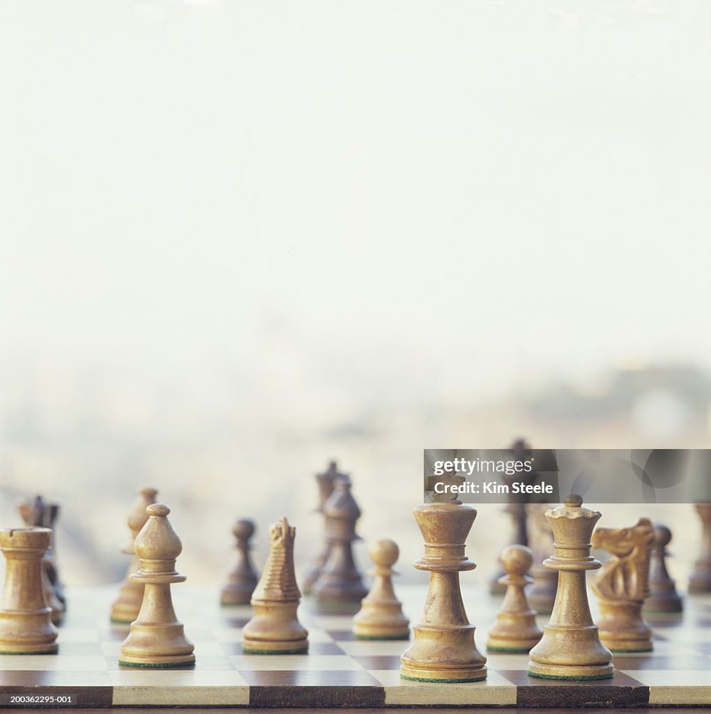 Chessboard with carved wooden pieces